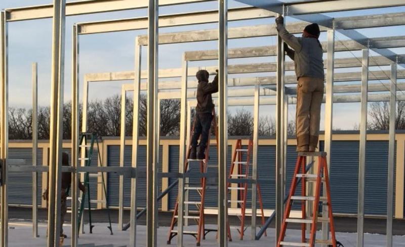 Winter construction site by Silo Steel Buildings: Dedicated workers braving the cold to construct a durable steel storage facility.