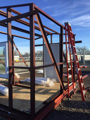 Silo Steel Buildings in action: Outdoor construction scene featuring the assembly of a mini shed.