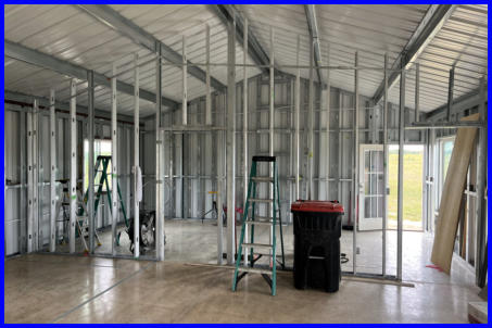 Construction in progress: Interior view of a commercial building by Silo Steel Buildings, featuring sturdy steel beams and roofing installation during the construction phase.